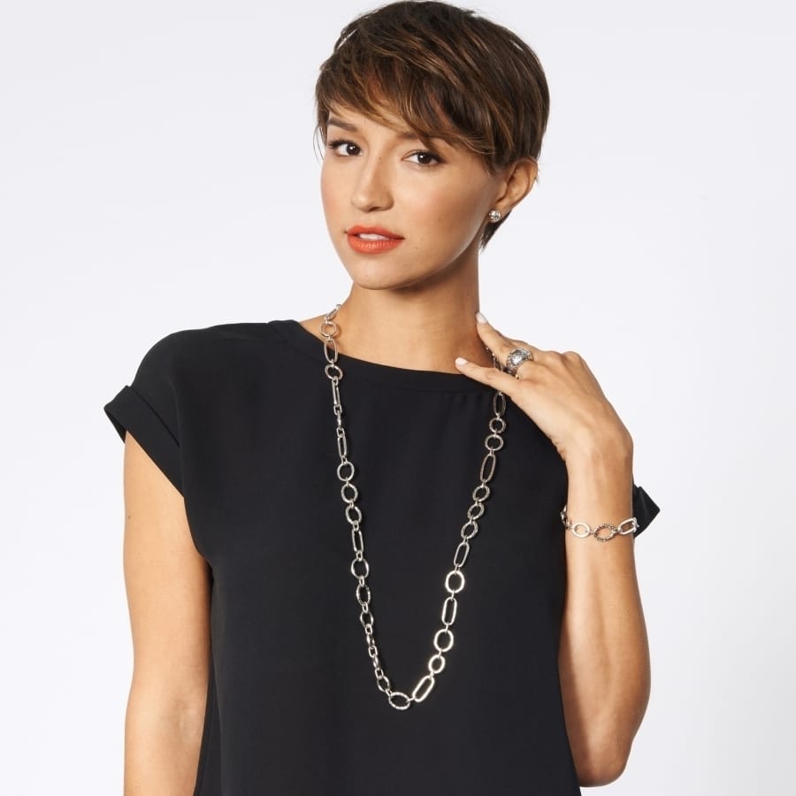 Model wearing a Brighton long silver-plated chain link necklace with coordinating Brighton ring and bracelet accessories