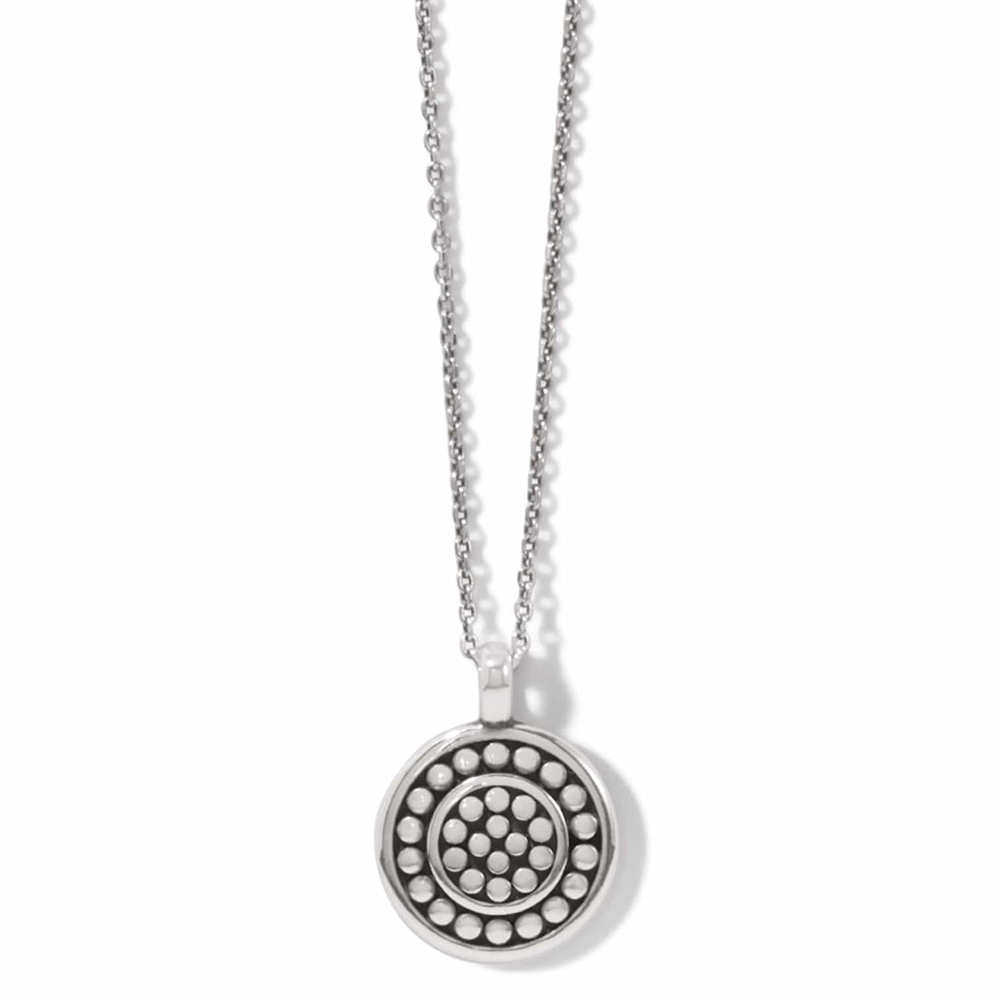 Brighton pendant necklace with silver-plated round medallion featuring concentric dotted circle patterns on a white background