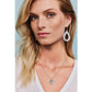 Model wearing Brighton silver-plated teardrop earrings with dotted texture paired with a matching round pendant necklace