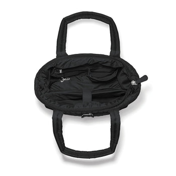 Brighton black quilted handbag shown open with interior pockets, zippered compartment, and dual handles on a white background