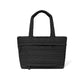 Brighton tote handbag in black quilted fabric with heart pattern, dual top handles, and front pocket on a white background