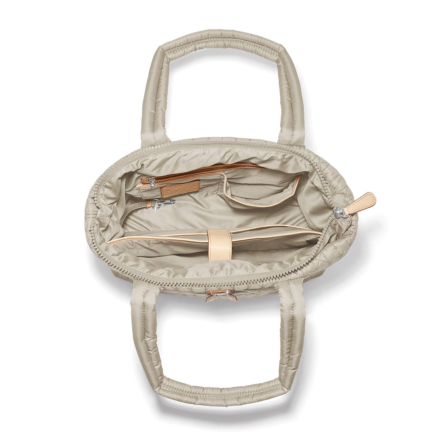 Brighton quilted handbag interior view showing beige lining with zip pocket and leather trim on a white background