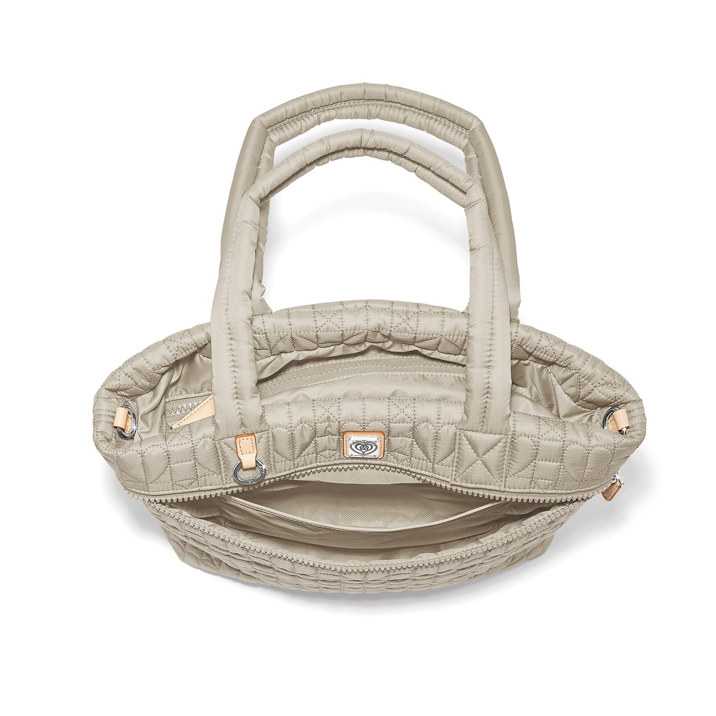 Brighton quilted handbag shown from above with open interior view, dual padded handles, and logo tag on a white background