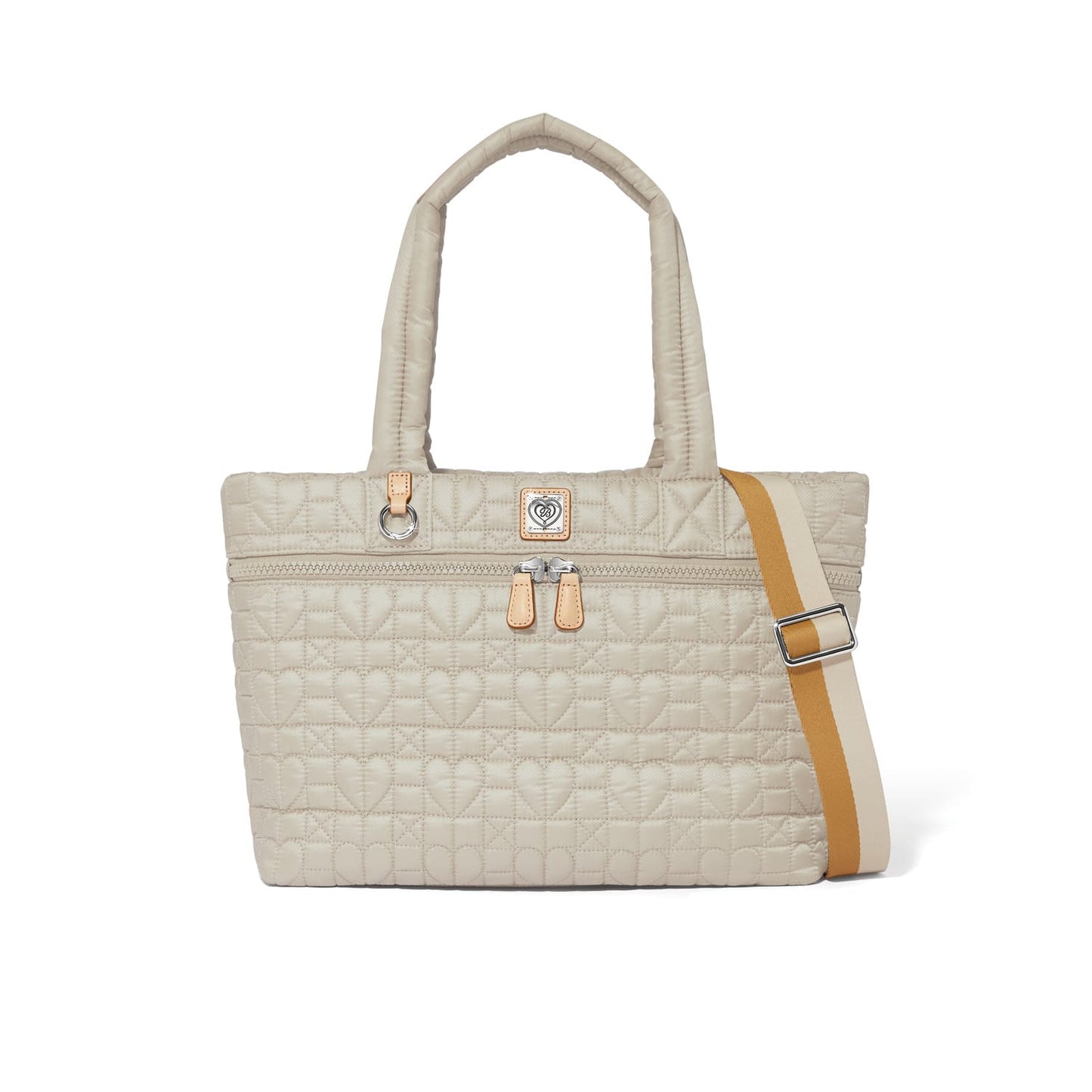 Brighton tote handbag in beige quilted heart pattern with dual handles and tan-striped adjustable crossbody strap on a white background
