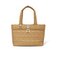 Brighton tote handbag in tan quilted heart pattern with dual handles and front zip pocket on a white background