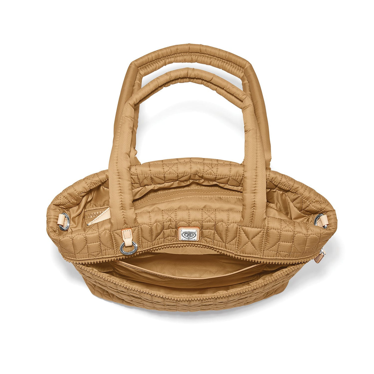 Brighton quilted handbag shown open with tan nylon exterior, interior zip pocket, and silver-tone hardware on a white background