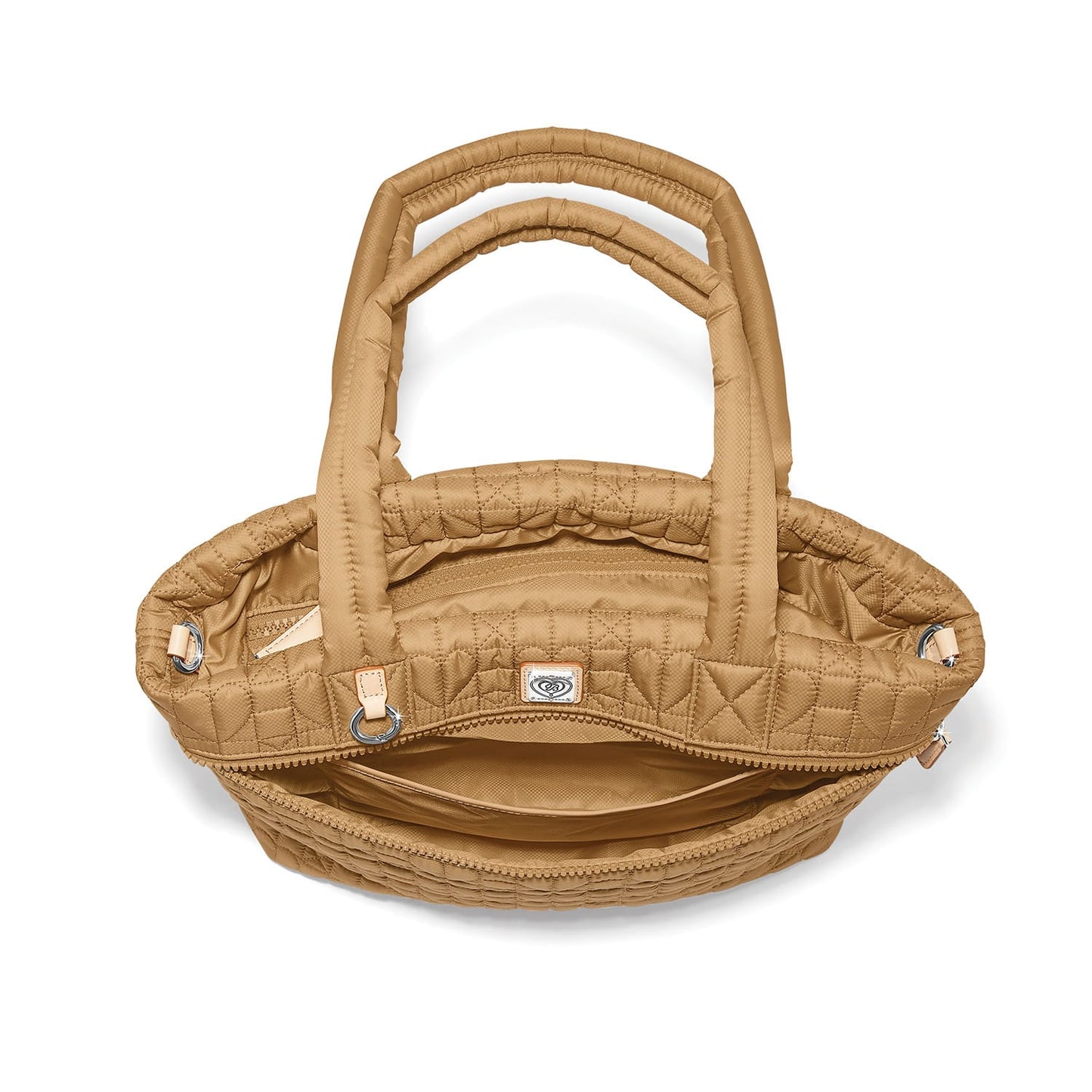 Brighton quilted handbag shown open with tan nylon exterior, interior zip pocket, and silver-tone hardware on a white background