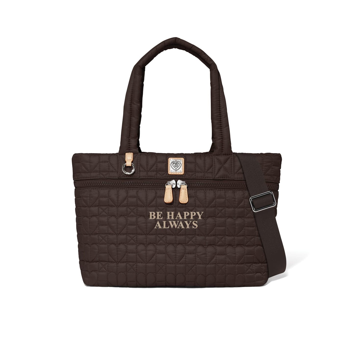 Brighton quilted tote handbag in brown with heart pattern, dual handles, and "Be Happy Always" text on a white background