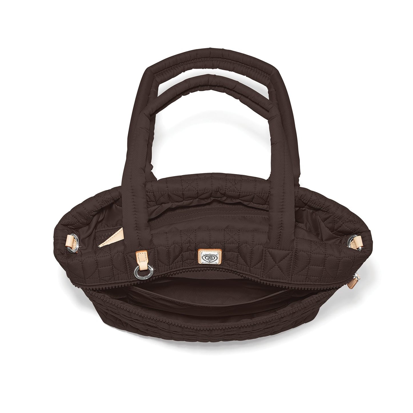 Brighton quilted handbag shown from above with open interior, dual padded handles, and silver-tone hardware on a white background
