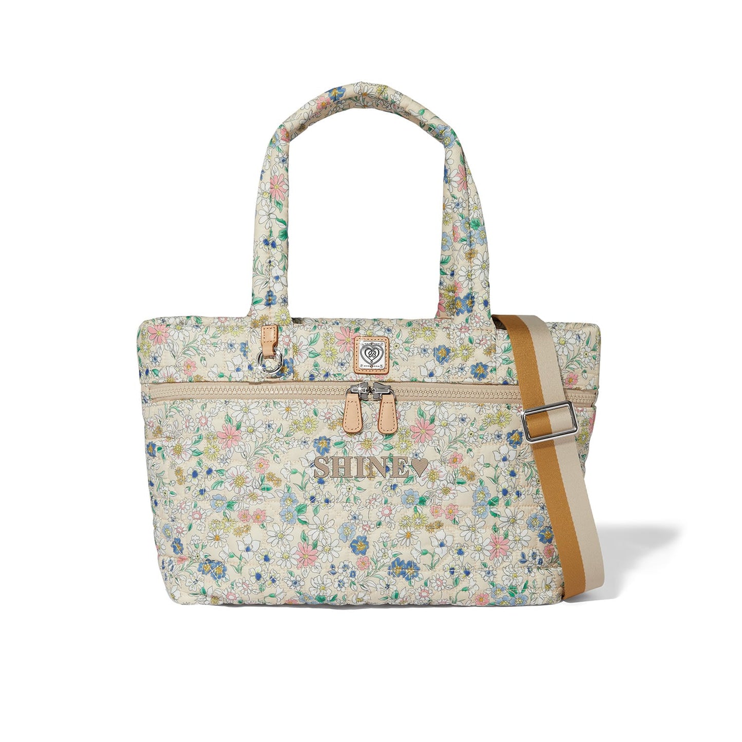 Brighton tote handbag with quilted floral print, SHINE lettering, dual handles, and tan crossbody strap on a white background