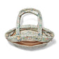 Brighton handbag interior view with floral print quilted fabric, zippered pocket, and tan lining on a white background