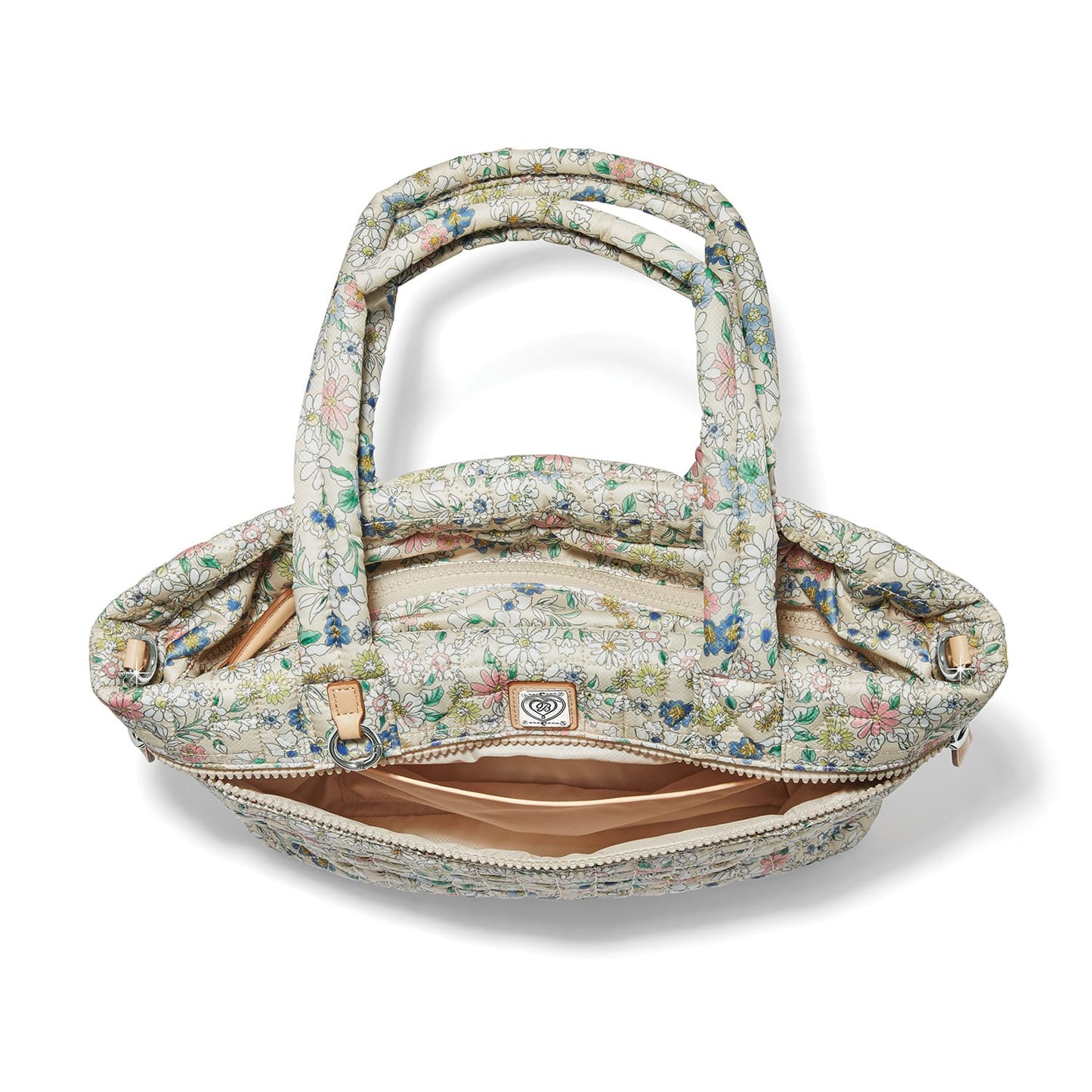 Brighton handbag interior view with floral print quilted fabric, zippered pocket, and tan lining on a white background