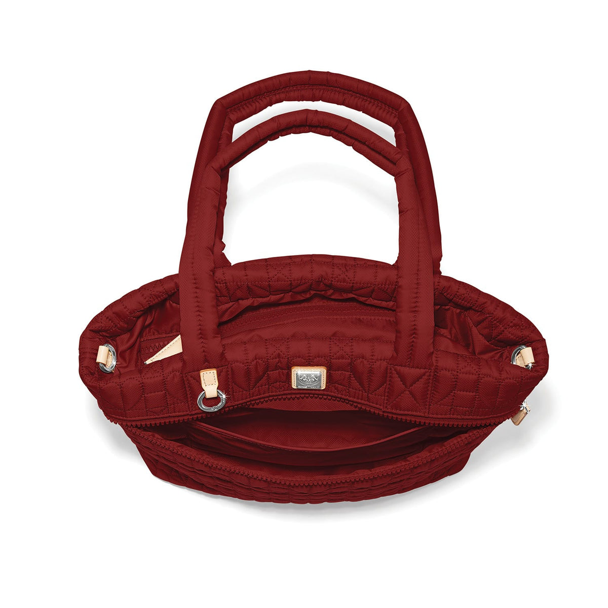 Brighton quilted handbag shown open with dark red interior, dual handles, and silver-tone hardware on a white background