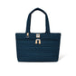 Brighton tote handbag in navy quilted heart pattern with leather trim, dual handles, and zip pocket on a white background