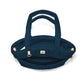 Brighton quilted handbag shown from above with open interior, dual top handles, and leather tabs on a white background