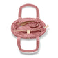 Brighton pink quilted handbag interior view showing zip pocket, tan leather trim, and dual handles on a white background