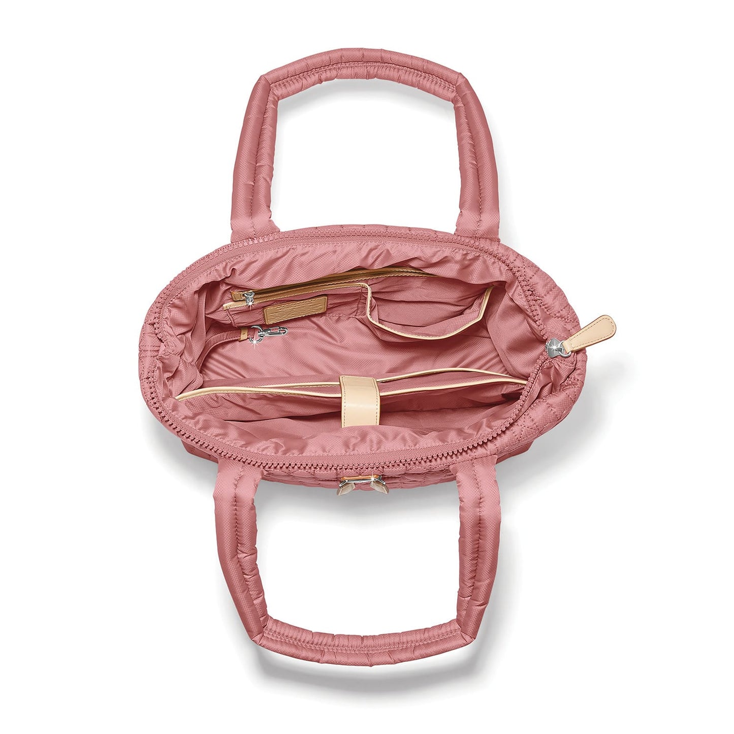 Brighton pink quilted handbag interior view showing zip pocket, tan leather trim, and dual handles on a white background