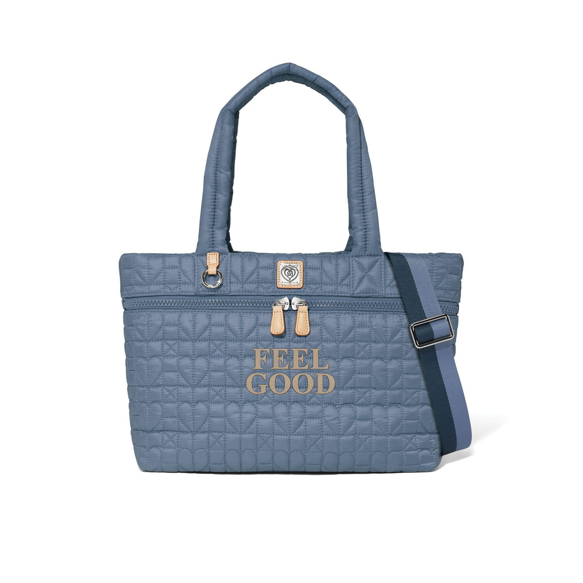 Brighton blue quilted tote handbag with heart pattern, Feel Good print, and navy crossbody strap on a white background