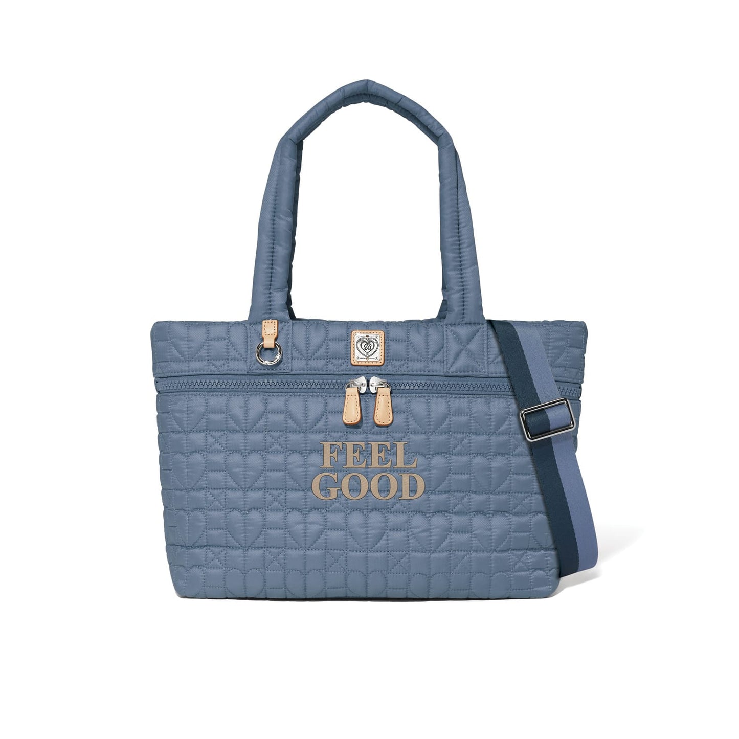 Brighton blue quilted tote handbag with heart pattern, Feel Good print, and navy crossbody strap on a white background