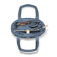 Brighton blue quilted handbag interior view showing zippered pockets and tan leather trim on a white background