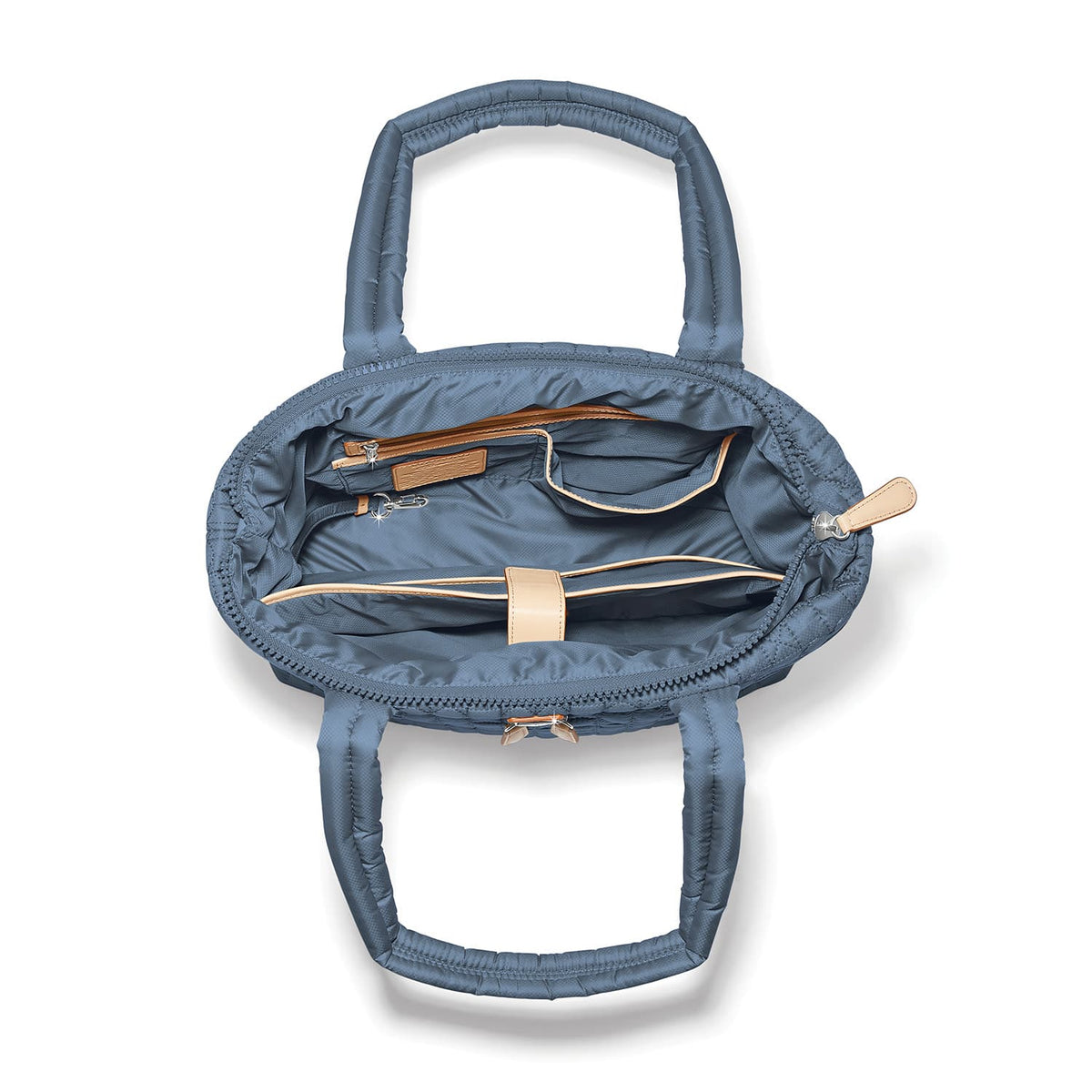 Brighton blue quilted handbag interior view showing zippered pockets and tan leather trim on a white background