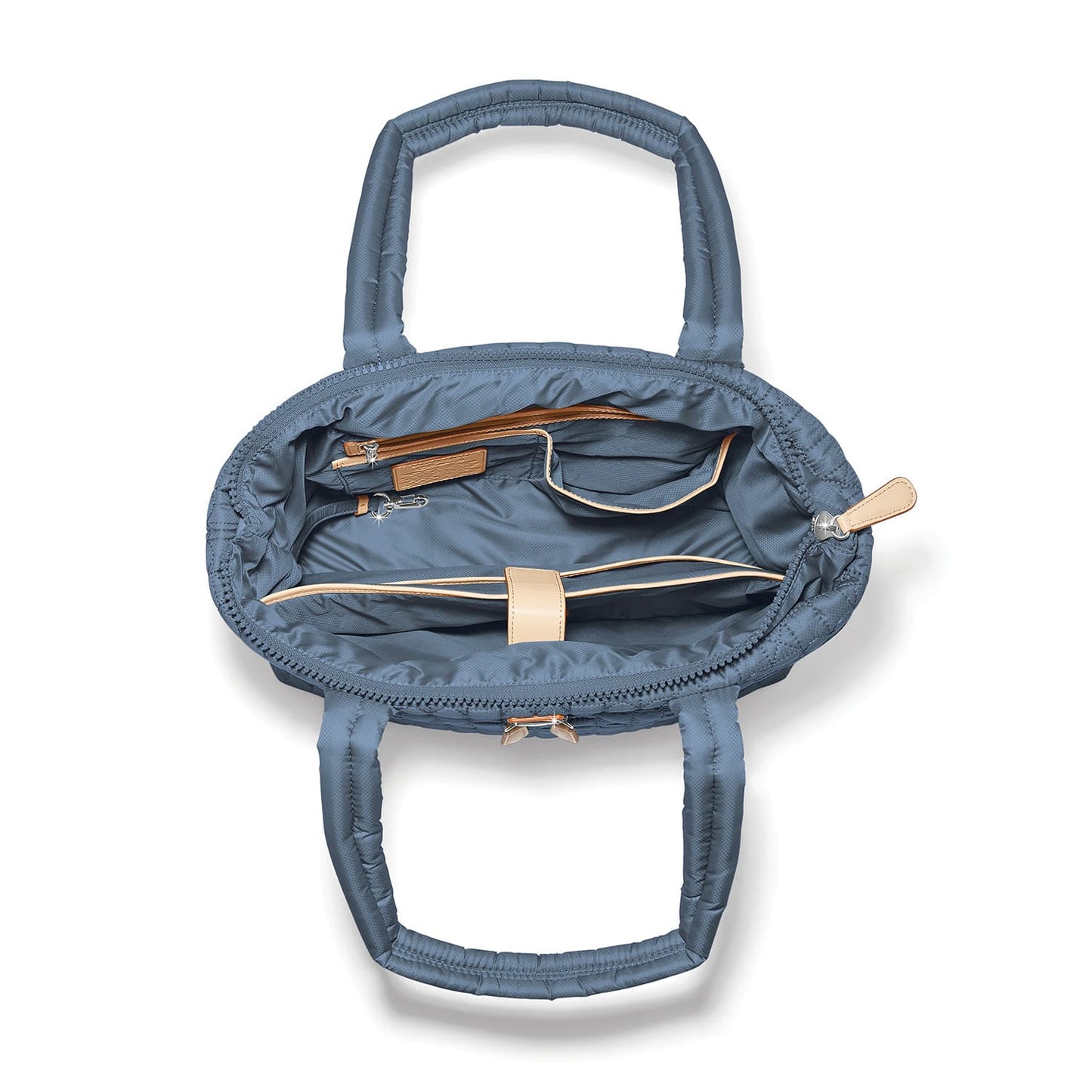 Brighton blue quilted handbag interior view showing zippered pockets and tan leather trim on a white background