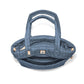 Brighton quilted handbag shown open from above with blue nylon exterior, dual handles, and interior zip pocket on a white background