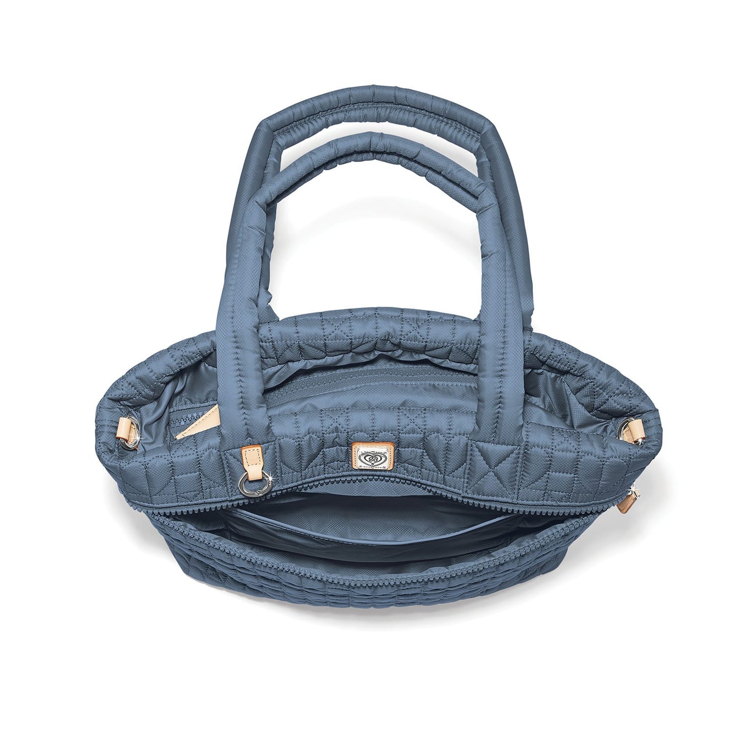 Brighton quilted handbag shown open from above with blue nylon exterior, dual handles, and interior zip pocket on a white background
