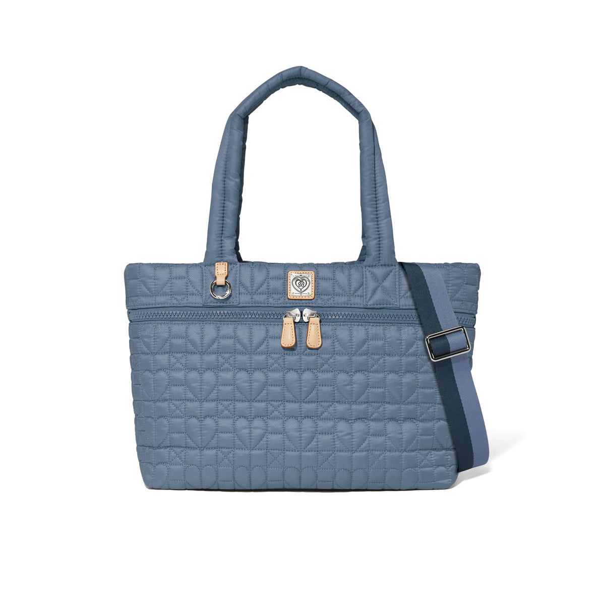 Brighton tote handbag in blue quilted heart pattern with leather zipper pulls and adjustable crossbody strap on a white background