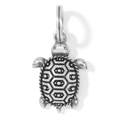 Brighton turtle charm with silver-plated patterned shell, green crystal eyes, and split ring on a white background