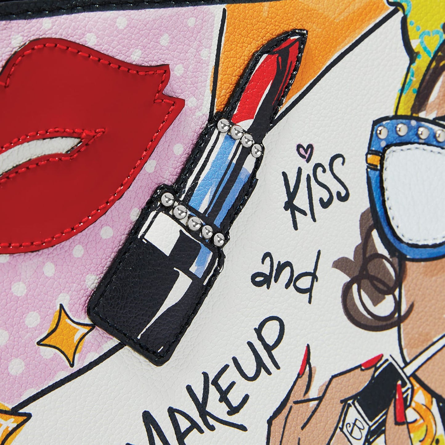 Close-up of Brighton pop-art print pouch with red lips applique, lipstick motif, studs, and Kiss and Makeup text