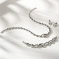 Brighton silver-plated jewelry set styled with matching chain link necklace, bracelet, and crystal drop earrings on neutral background