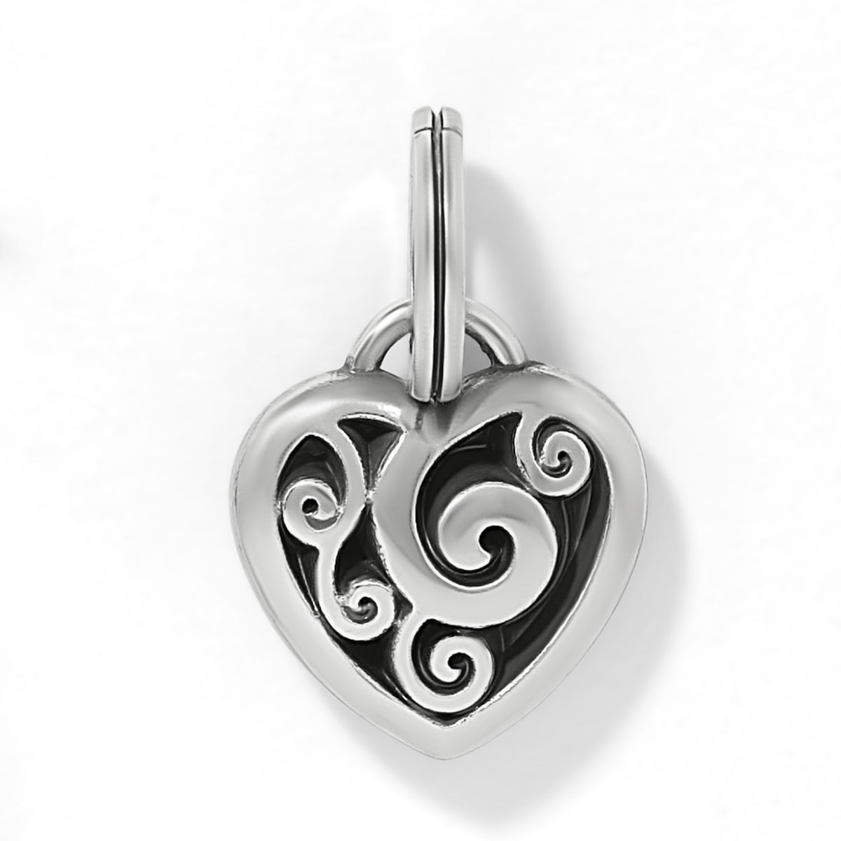 Brighton heart charm with silver-plated scroll filigree design over black background on a white background