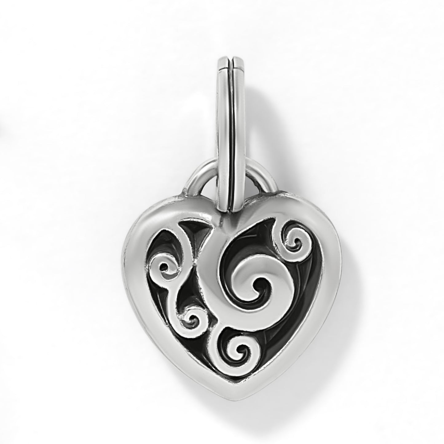 Brighton heart charm with silver-plated scroll filigree design over black background on a white background