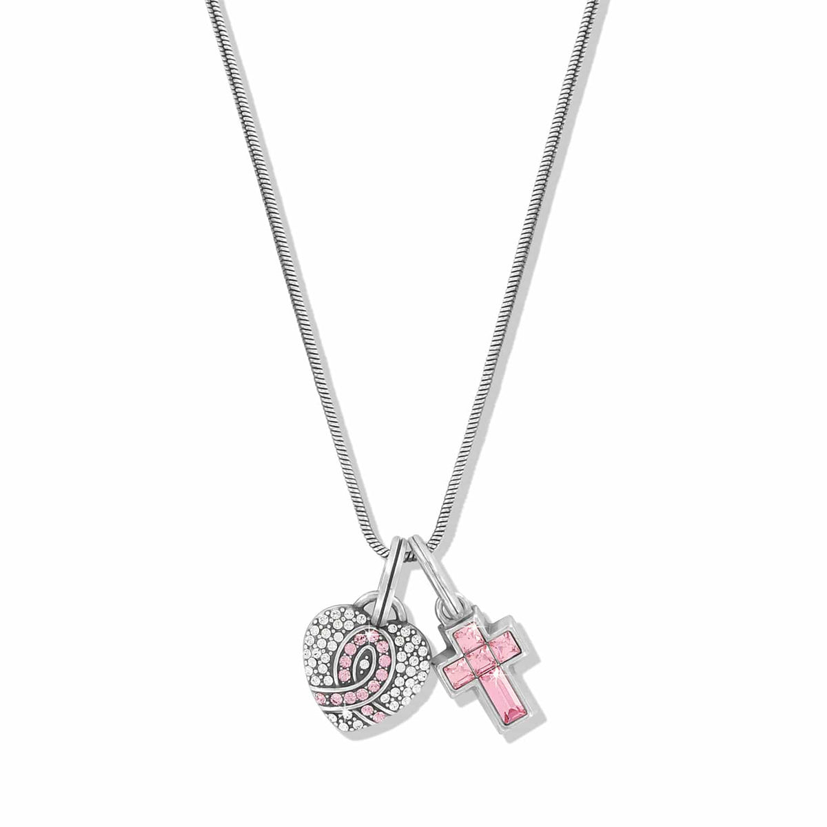 Brighton pendant necklace with silver-plated heart and pink crystal cross charms on a white background