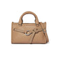 Brighton handbag in tan pebbled leather with studded belt detail, silver-tone hardware, and rolled handles on a white background