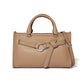 Brighton tan pebbled leather handbag with studded belt detail, silver-tone hardware, and adjustable crossbody strap on a white background