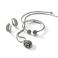 Brighton silver-plated jewelry set styled with beaded pendant necklace, cuff bracelet, and matching hoop earrings on white