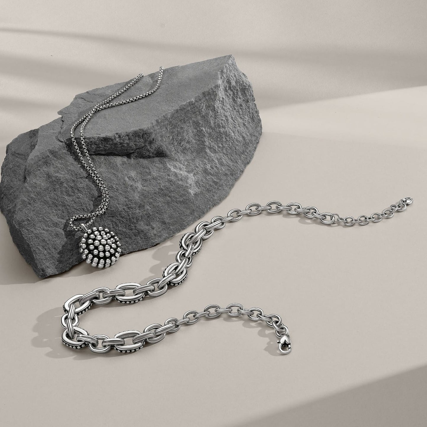 Brighton silver-plated jewelry styled with a chunky link bracelet and beaded pendant necklace on gray stone