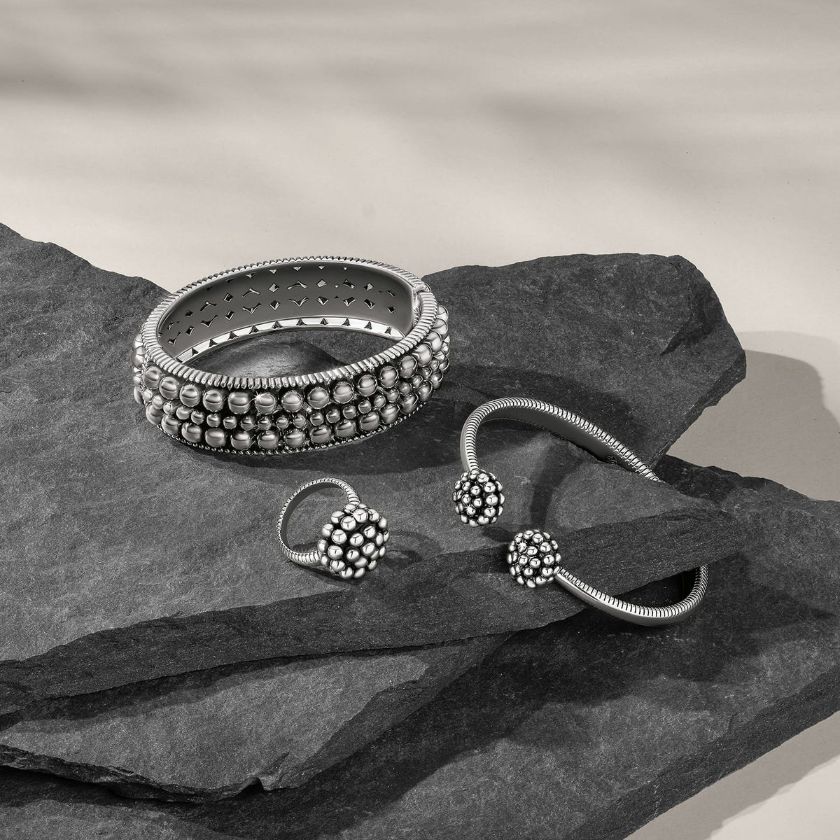 Brighton silver-plated beaded bangle bracelet and cuff bracelets styled with dark slate stones on a neutral background