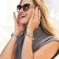 Pretty Tough Droplet Hinged Bangle worn by a model, demonstrating the fit and stylish appearance