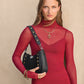 Model with a Brighton black studded shoulder handbag featuring mixed gold and silver-tone stud accents