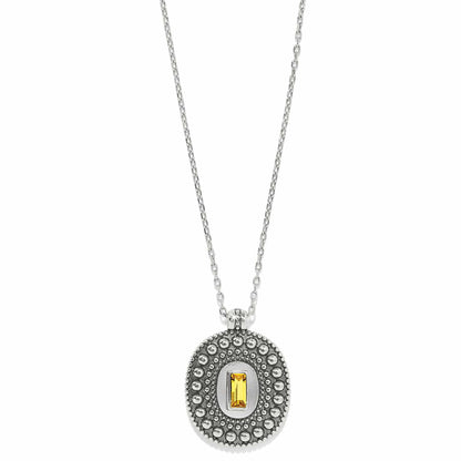 Brighton pendant necklace with silver-plated beaded oval and yellow crystal baguette center on a white background