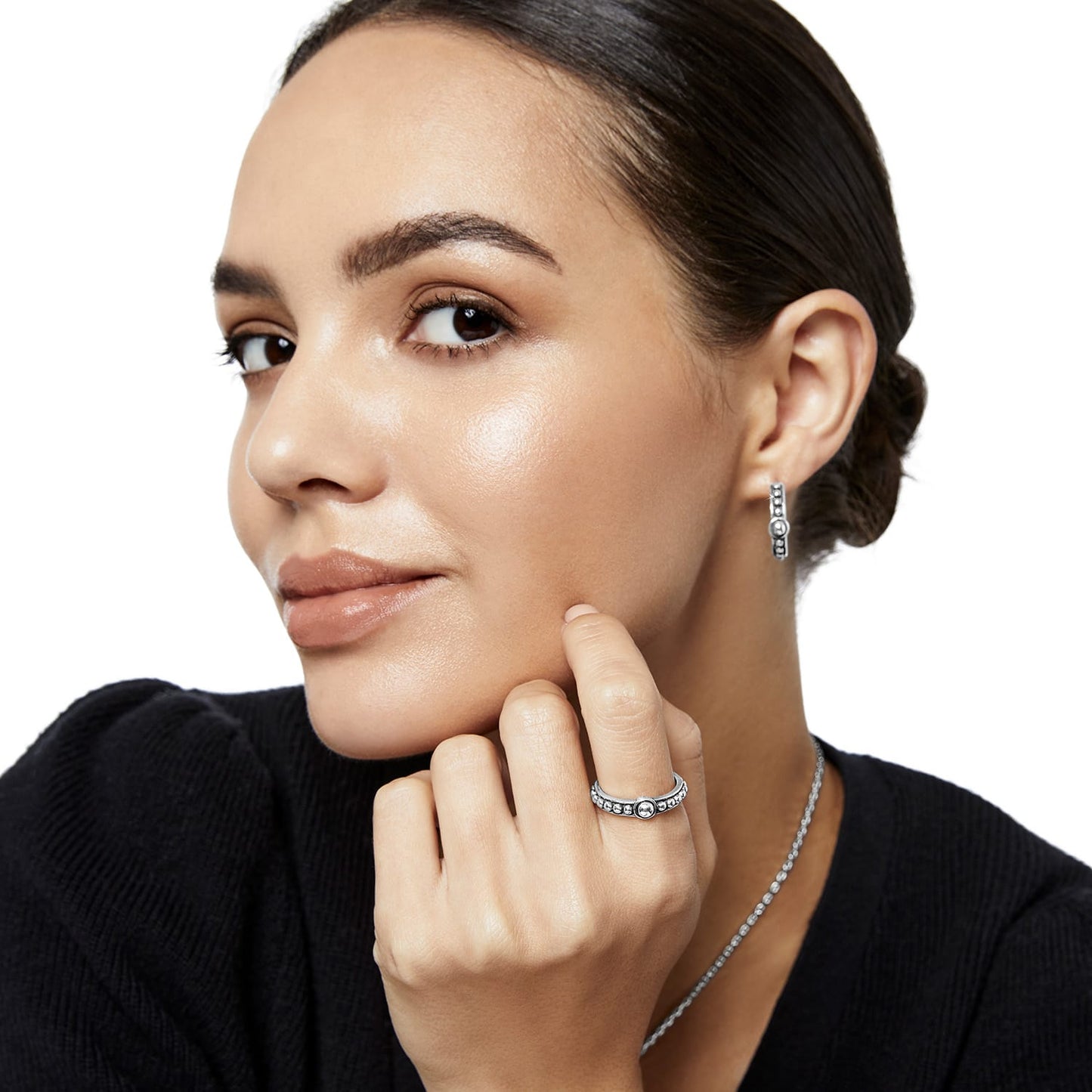 Model wearing Brighton silver-plated beaded hoop earrings paired with a matching beaded ring and delicate chain necklace