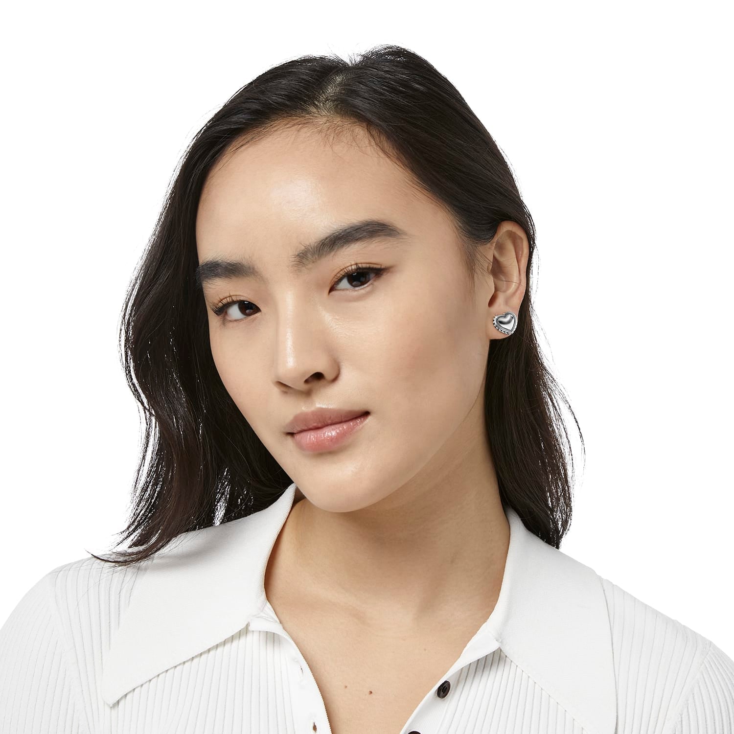 Model wearing Brighton heart-shaped stud earrings with silver-plated finish and beaded border detail