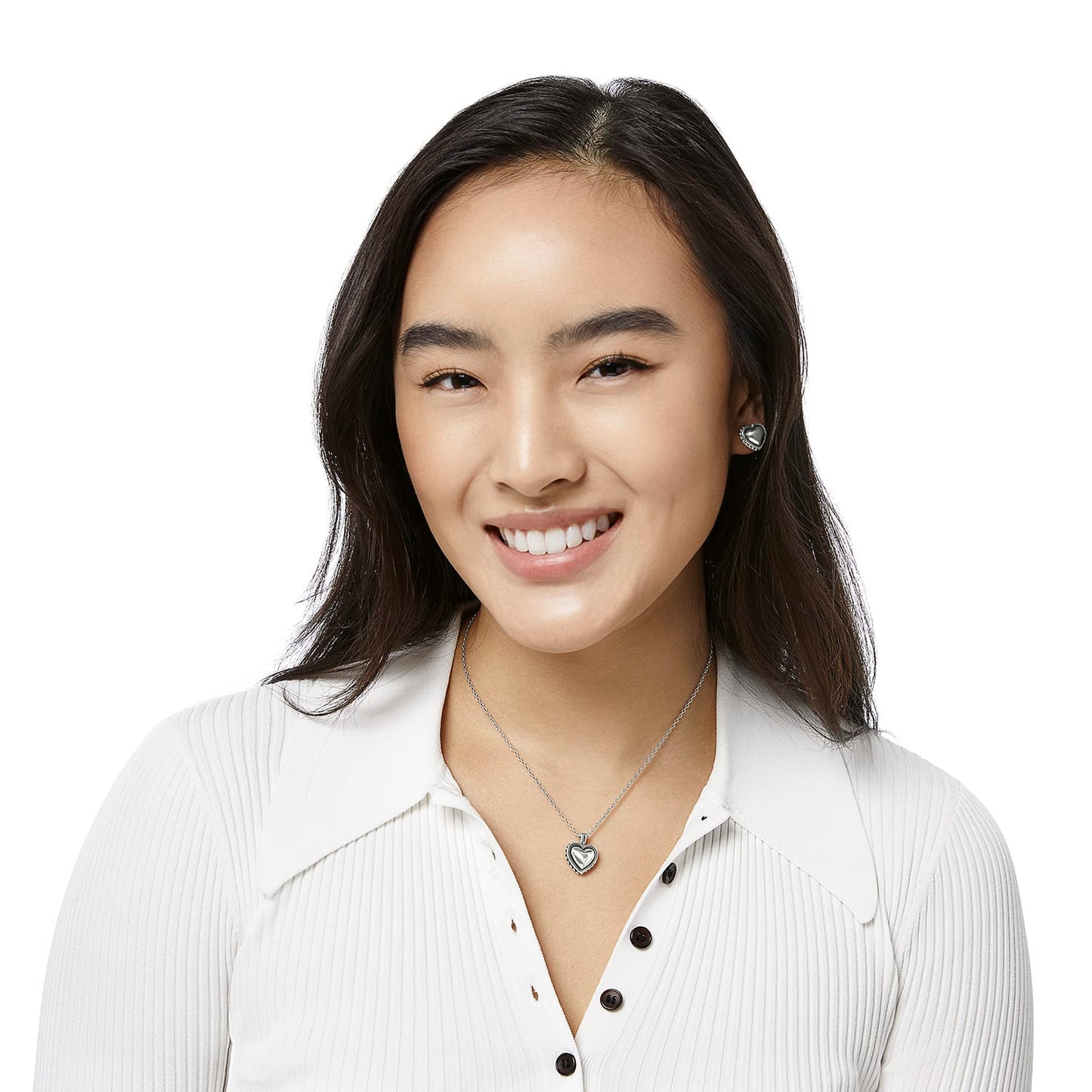 Model wearing a Brighton silver-plated heart pendant necklace paired with matching silver-plated heart stud earrings