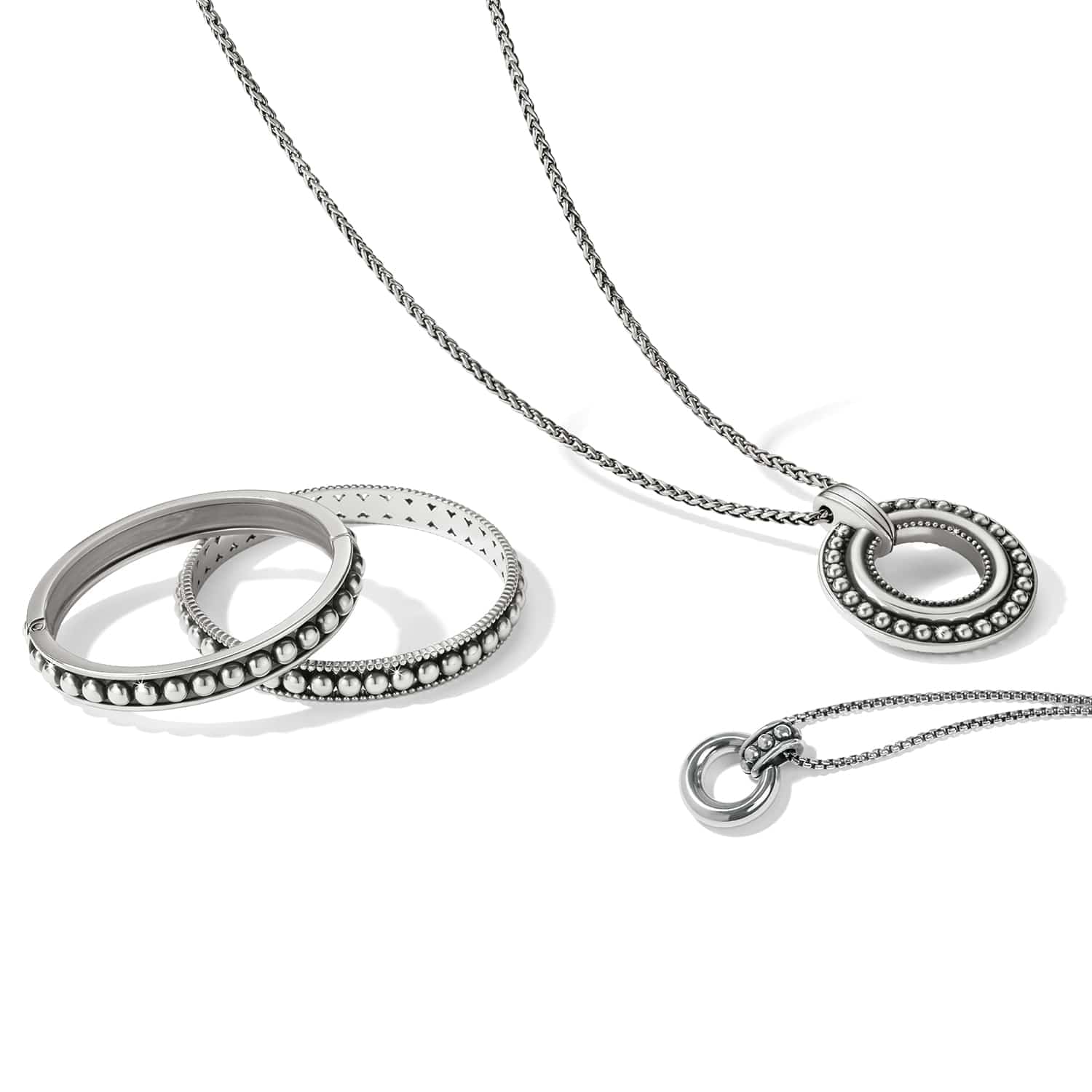 Brighton silver-plated pendant necklace styled with beaded bangle bracelets on a white background