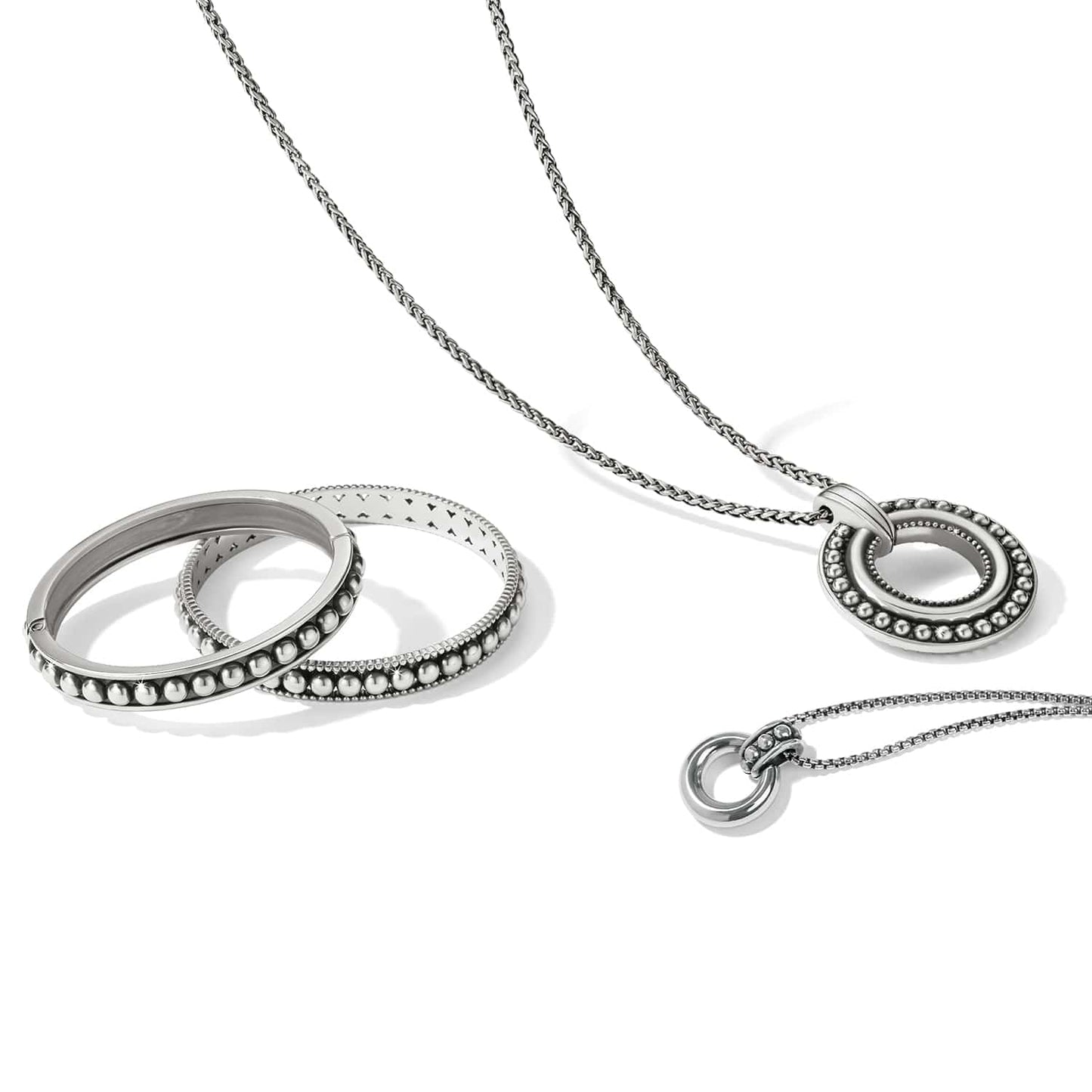 Brighton silver-plated pendant necklace styled with beaded bangle bracelets on a white background