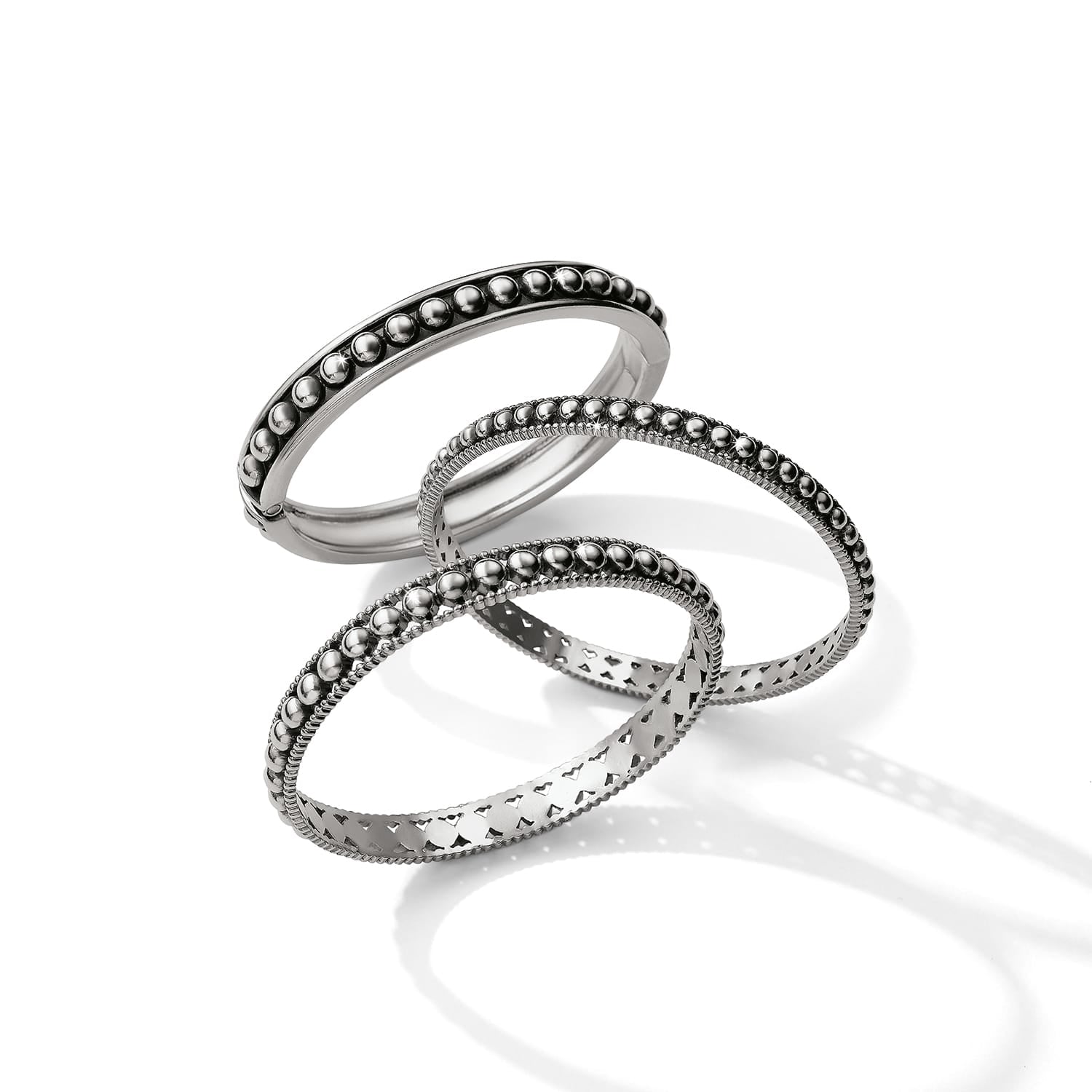 Brighton silver-plated bangle bracelets with beaded, studded, and cut-out heart designs on a white background