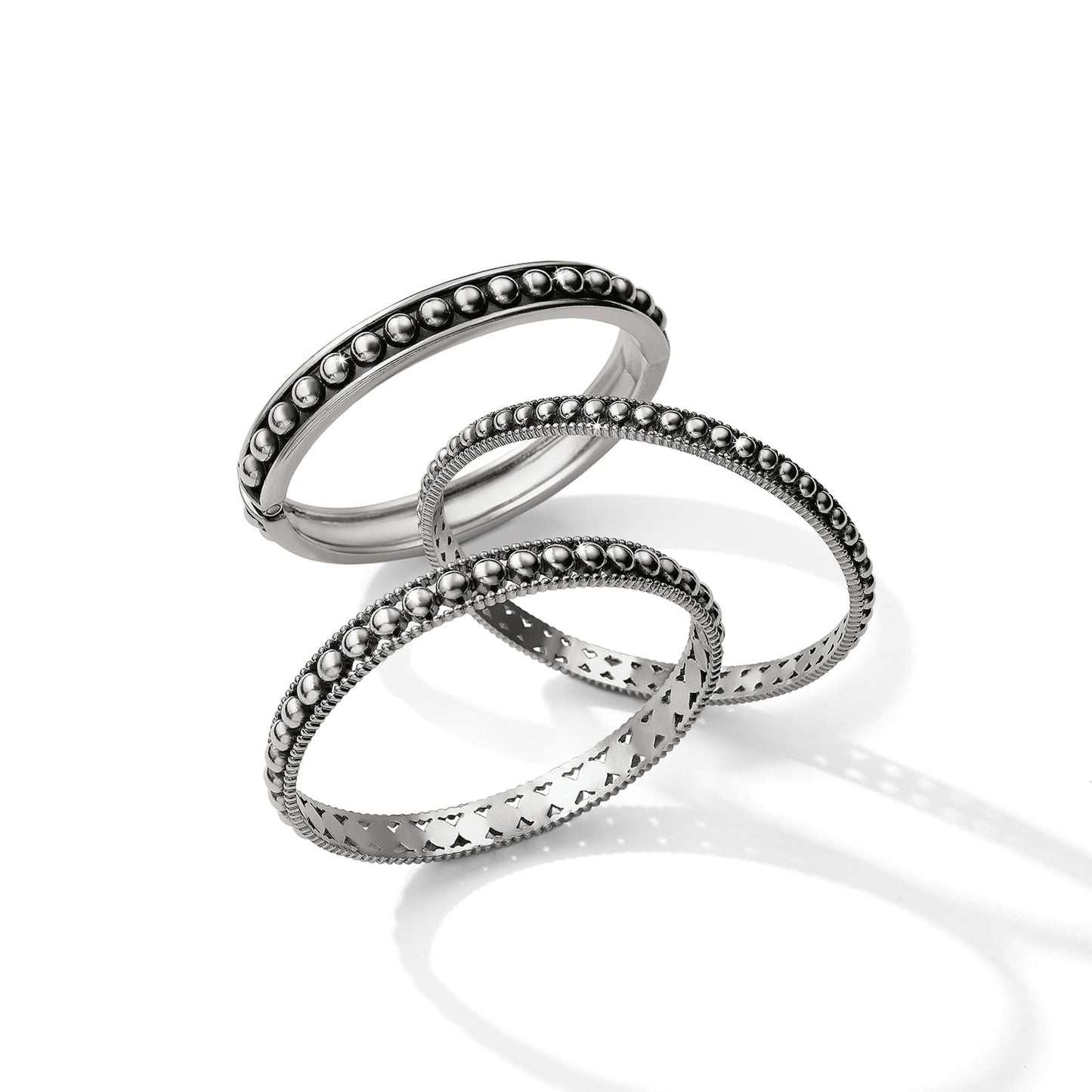 Brighton silver-plated bangle bracelets with beaded, studded, and cut-out heart designs on a white background